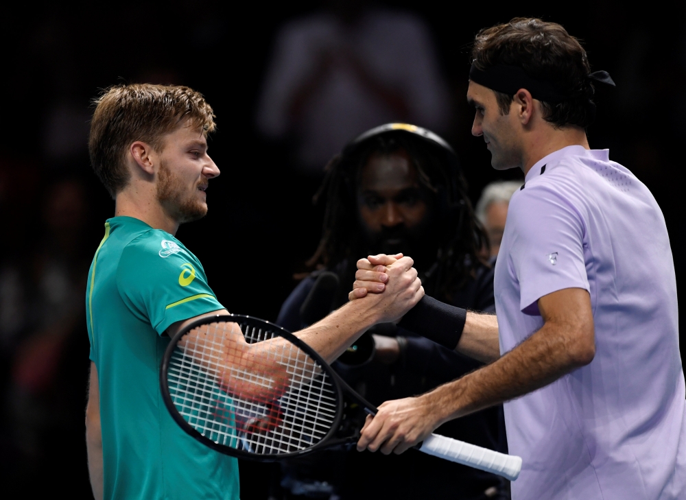 Belgium's David Goffin shakes hands with Switzerland's Roger Federer after winning their semifinal match of the ATP World Tour Finals at the O2 Arena, London, on Saturday. — Reuters