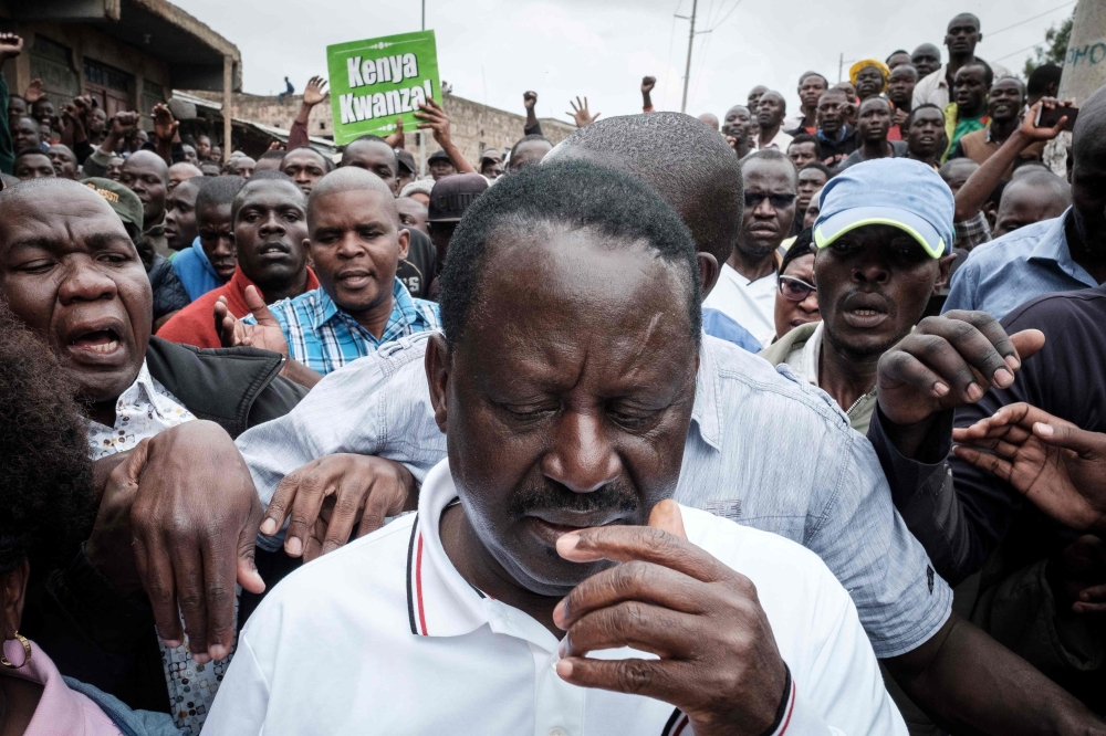 Kenya’s opposition party National Super Alliance (NASA) leader Raila Odinga, center, leaves after seeing a dead body on ground at Riverside slum in Nairobi, Kenya, on Sunday. — AFP