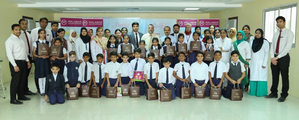 MIS and Malabar Gold & Diamonds officials with children and their awards 