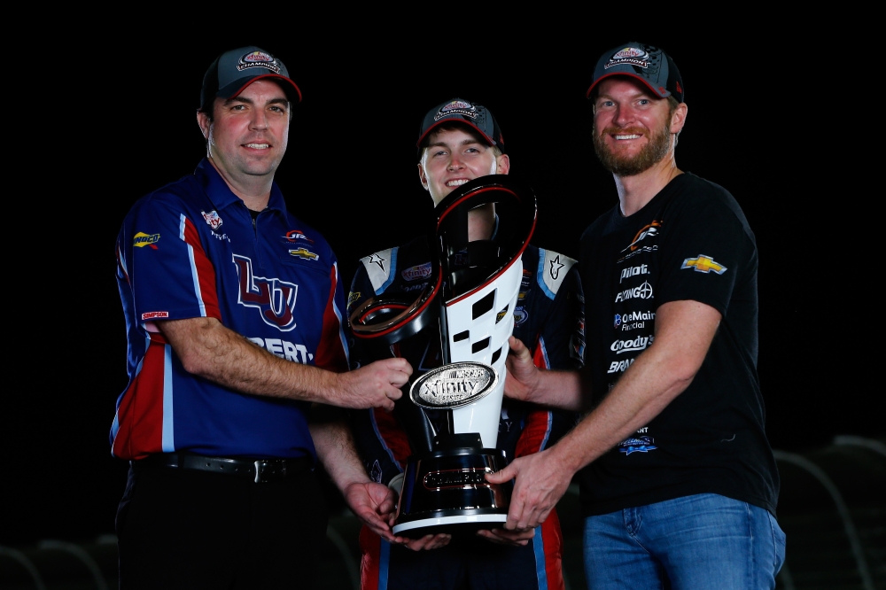 William Byron, driver of the No. 9 Liberty University Chevrolet, his crew chief David Elenz and team owner Dale Earnhardt Jr. pose for a photo with the champion's trophy after winning the NASCAR XFINITY series championship by finishing third during the NASCAR XFINITY Series Championship Ford EcoBoost 300 at Homestead-Miami Speedway on Sunday. — AFP