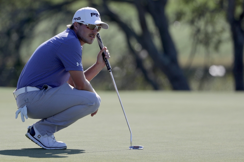 Austin Cook of the United States lines up a putt on the seventh green during the third round of The RSM Classic at Sea Island Golf Club Seaside Course on Saturday in St Simons Island, Georgia. — AFP