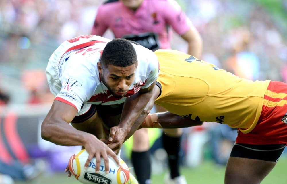 England’s Kallum Watkins (L) runs to score a try during their Rugby League World Cup quarterfinal match between England and Papua New Guinea in Melbourne on Sunday. — AFP