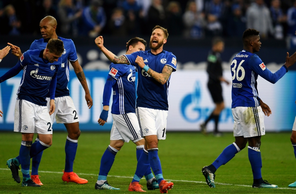 Schalke's Austrian striker Guido Burgstaller celebrates scoring with his teammates during the  Bundesliga football match against Hamburg SV in Gelsenkirchen on Sunday. — AFP