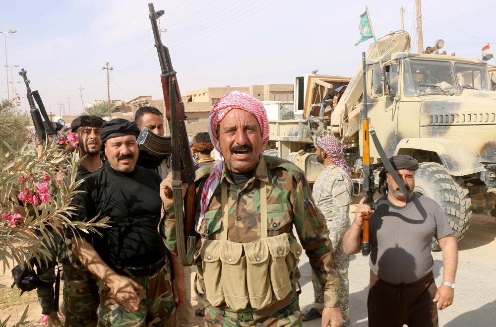Iraqi pro-government forces gather in Rawa after troops retook the Euphrates valley town from Daesh militants.  — AFP