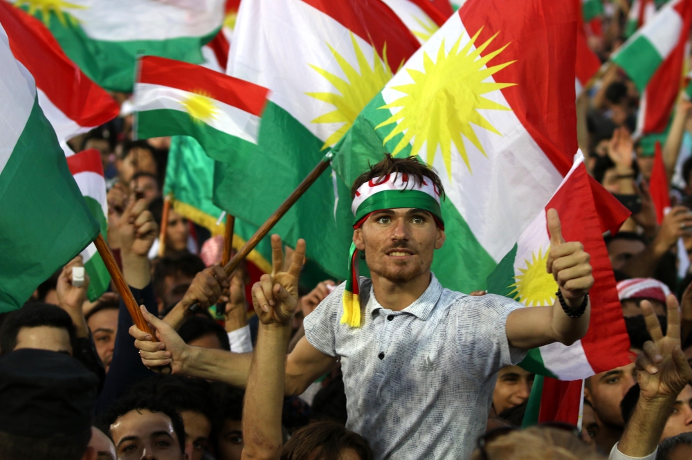 This file photo shows Iraqi Kurds flying Kurdish flags during an event to urge people to vote in the independence referendum in Irbil, the capital of the autonomous Kurdish region of northern Iraq. — AFP