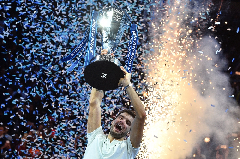 Bulgaria's Grigor Dimitrov holds the trophy as he celebrates winning his men's singles final match against Belgium's David Goffin on day eight of the ATP World Tour Finals tennis tournament at the O2 Arena in London on Sunday. — AFP