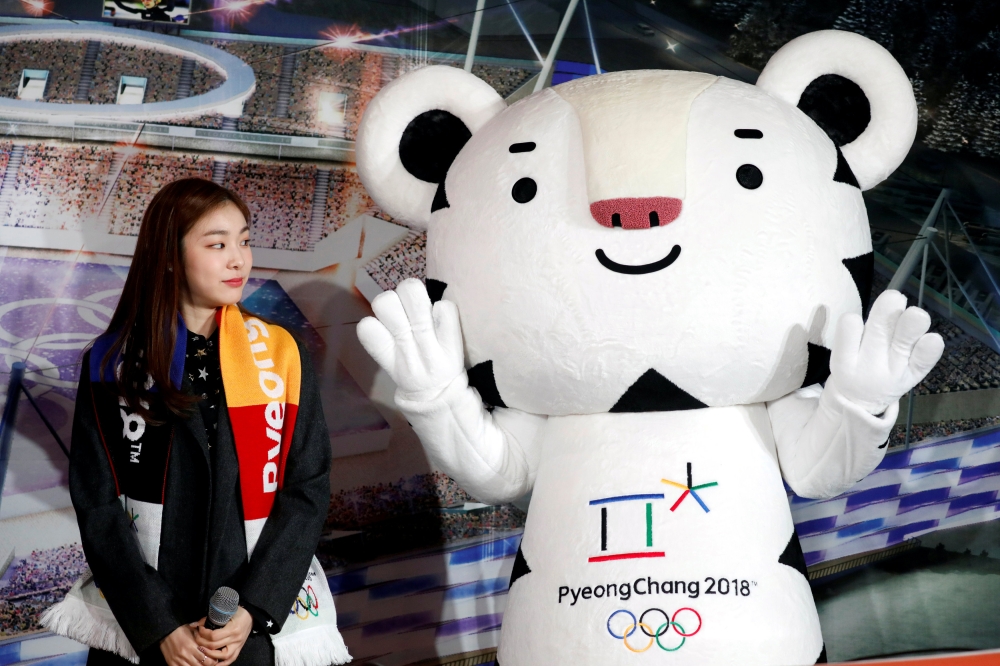 The Pyeongchang Organizing Committee for the 2018 Olympic and Paralympic Winter Games (POCOG) Honorary Ambassador Kim Yuna looks at the Olympic mascot 