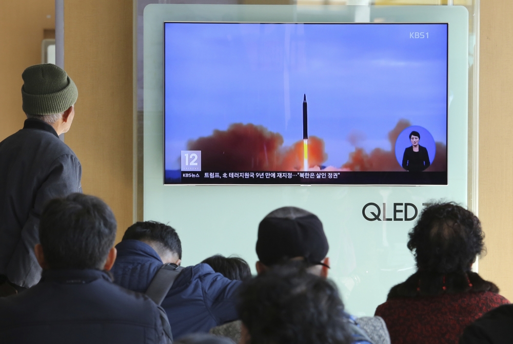 People watch a TV screen showing file footage of North Korea’s missile launch at Seoul Railway Station in Seoul, South Korea, on Tuesday. — AP