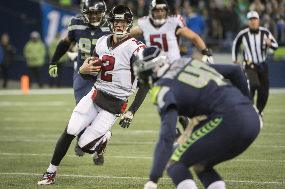 Atlanta Falcons quarterback Matt Ryan (2) picks up a first down during the second half against the Seattle Seahawks at CenturyLink Field. The Falcons won 34-31. — Reuters