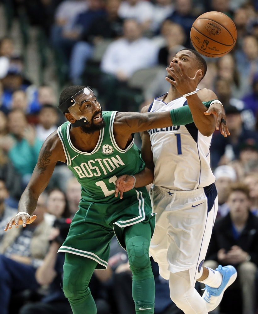 Boston Celtics' Kyrie Irving (11) has the ball stripped away by Dallas Mavericks' Dennis Smith Jr., right, in the second half of an NBA basketball game, Monday, in Dallas. — AP