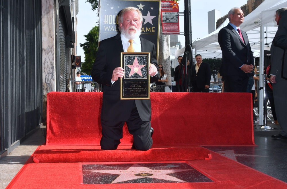 Actor Nick Nolte poses on his Hollywood Walk of Fame Star after it was unveiled in Hollywood, California, on Tuesday. Nolte was the recipient of the 2,623rd star in the category of Motion Pictures. - AFP