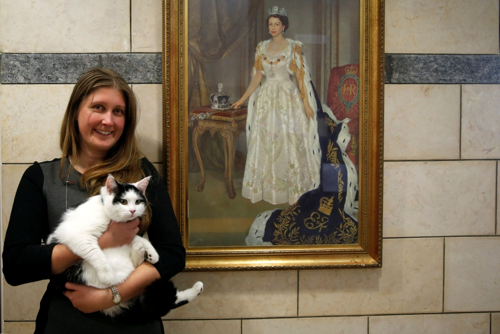 Laura Dauban, deputy ambassador of the United Kingdom to Jordan, poses with Lawrence of Abdoun, the first diplo-cat to be appointed by the British Embassy in Jordan, at the embassy headquarters in Amman. - Reuters