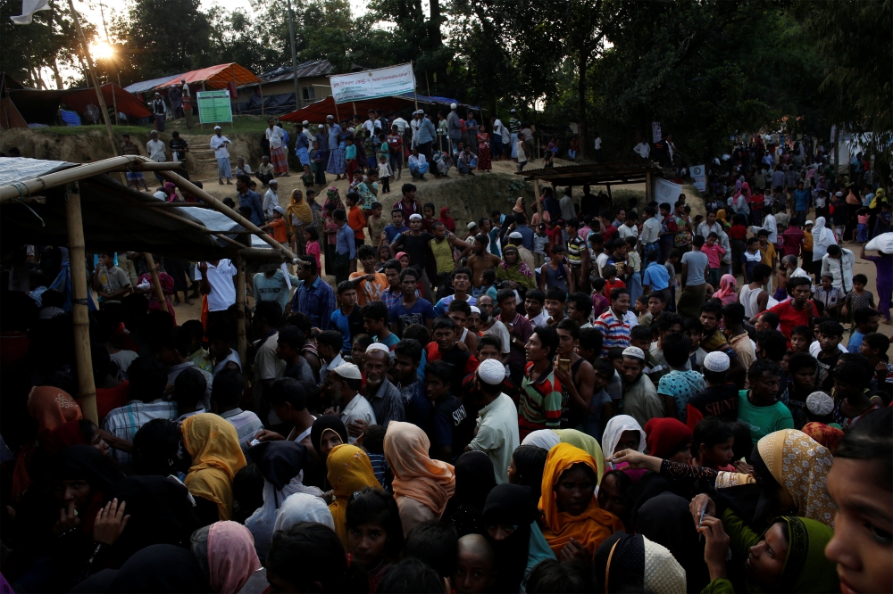 Rohingya refugees line up to receive food supplies at Hakim Para refugee settlement near Cox’s Bazar, Bangladesh, on Tuesday. — Reuters