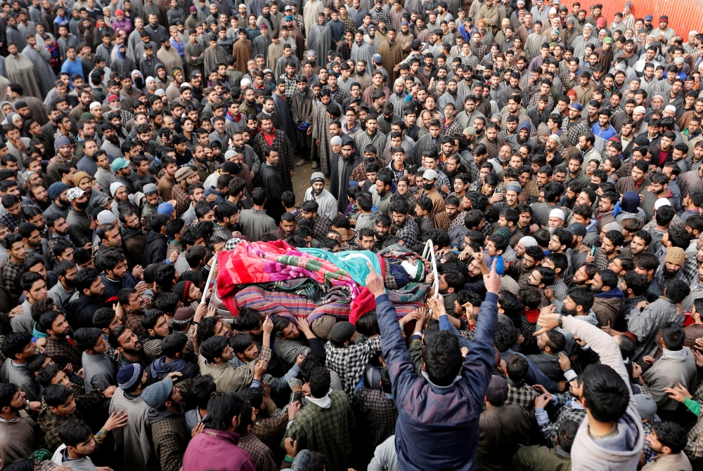 People shout slogans as they carry the body of a suspected militant, who according to the local media was killed in a gun battle with Indian security forces on Monday in Seer village, during his funeral procession at Lurrow village in Kashmir’s Tral town on Tuesday. — Reuters
