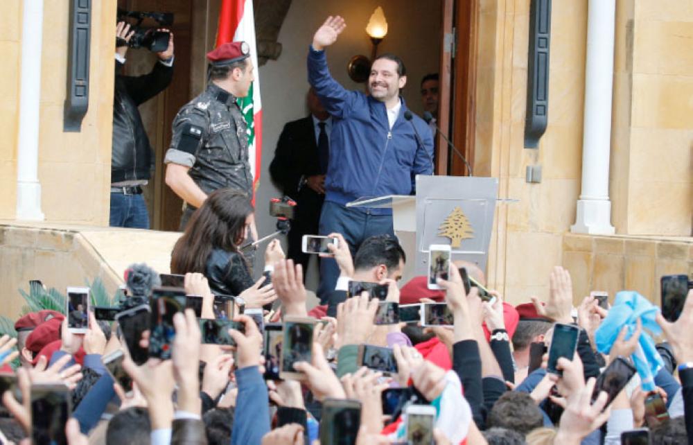 
Saad Hariri who suspended his decision to resign as prime minister gestures to his supporters at his home in Beirut, Lebanon, Wednesday. — Reuters