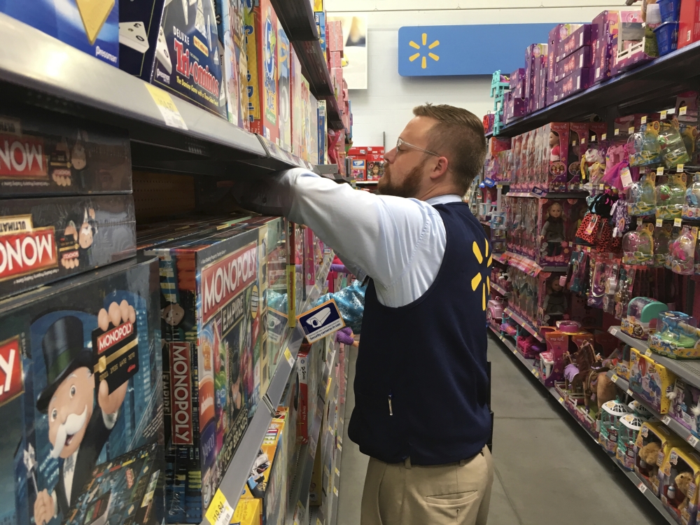 In this file photo, Denver Walmart Supercenter employee Aaron Sanford stocks toys on shelves in preparation for a Thanksgiving night rush that kicks off Black Friday weekend. Retailers are kicking off the holiday shopping season with an eye toward wooing shoppers away from rivals.  — AP