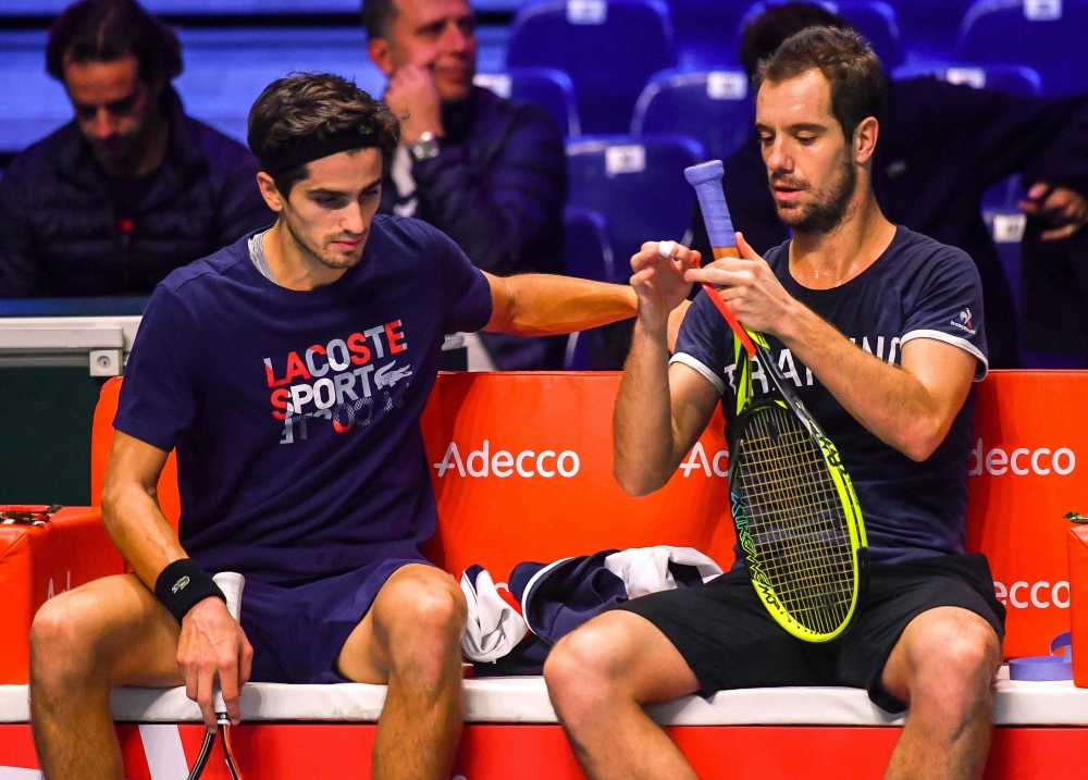 French tennis players Pierre-Hugues Herbert (L) and Richard Gasquet sit during a training session on Thursday at the Pierre-Mauroy stadium in Villeneuve d'Ascq, ahead of the Davis Cup World Group final between France and Belgium.  — AFP