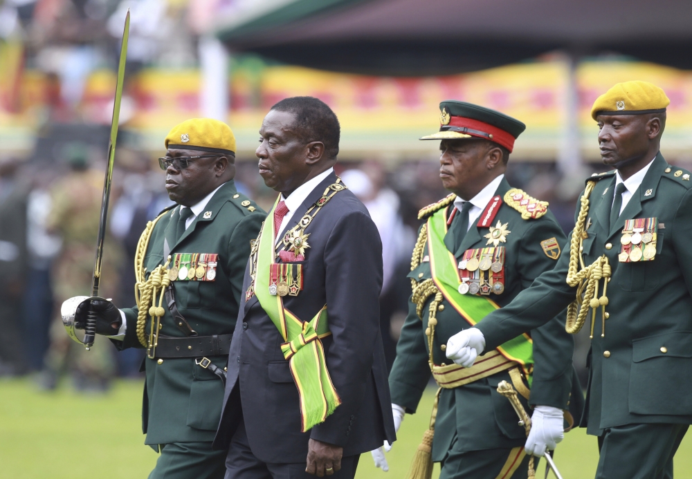 Emmerson Mnangagwa (second left) with Army General Constantino Chiwenga (second right) inspects the military parade after being sworn in as president at the presidential inauguration ceremony in the capital Harare, Zimbabwe, Friday. — AP
