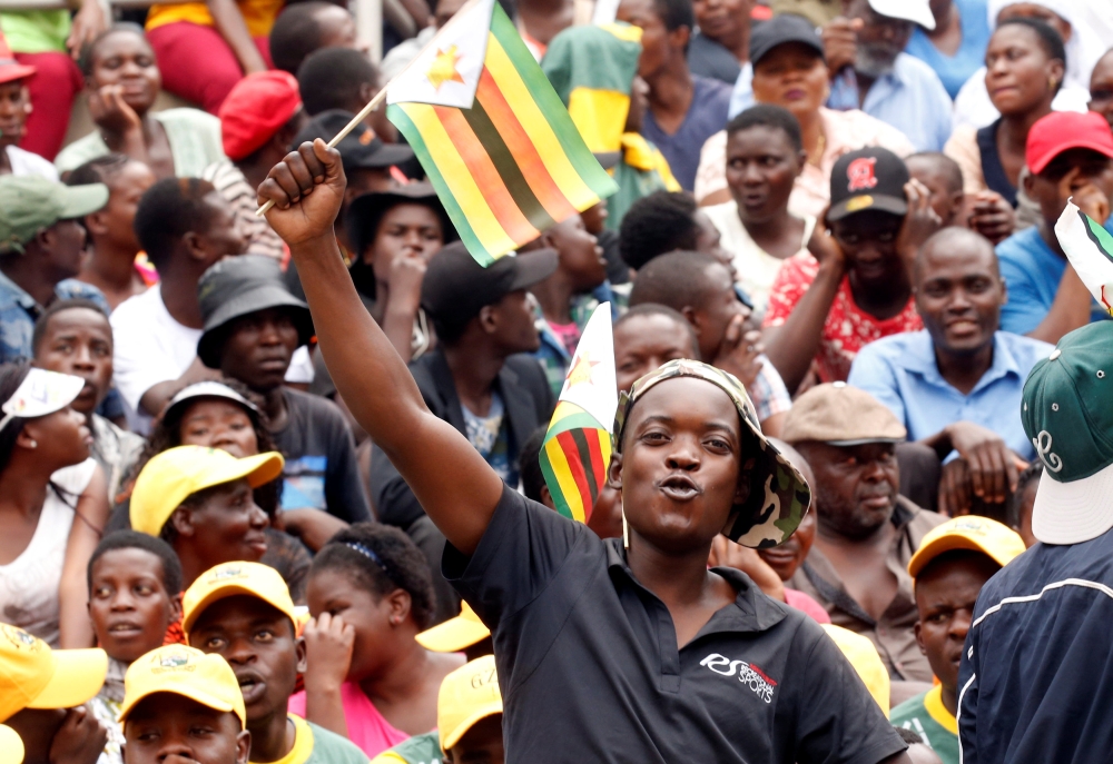 Emmerson Mnangagwa (second left) with Army General Constantino Chiwenga (second right) inspects the military parade after being sworn in as president at the presidential inauguration ceremony in the capital Harare, Zimbabwe, Friday. — AP