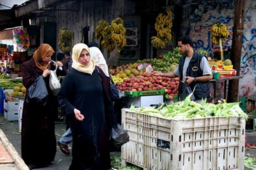 Palestinian women walk in Al-Maghazi refugee camp market, central Gaza strip. — Courtesy photo
