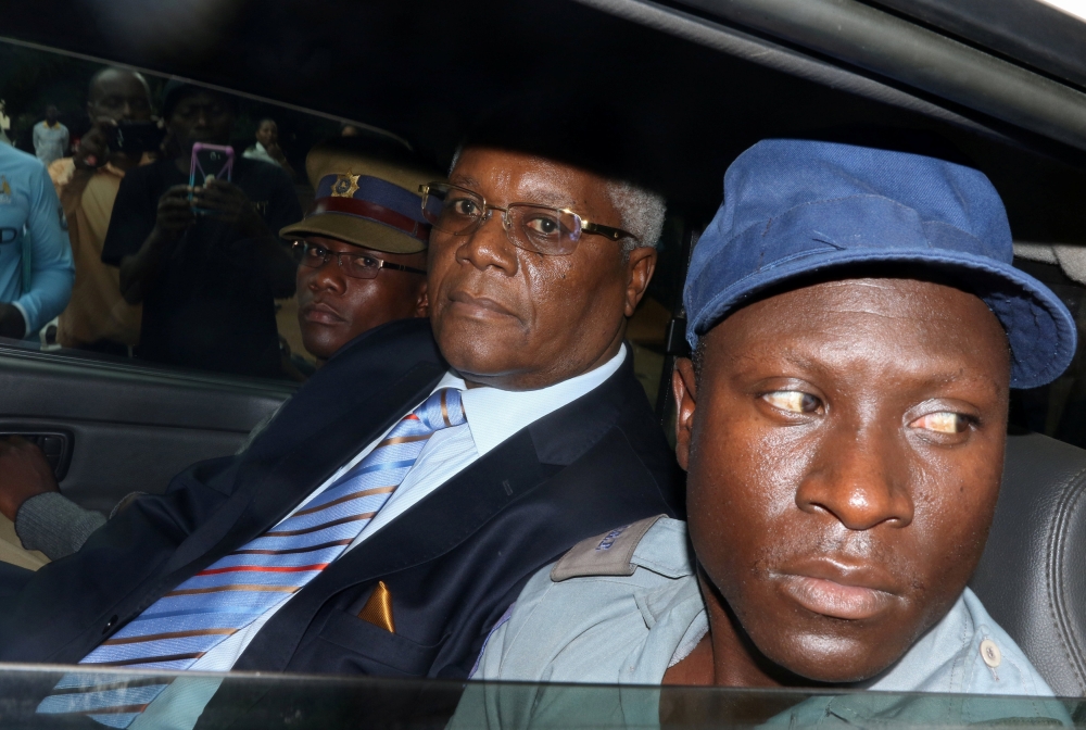 Former Zimbabwe Finance Minister Ignatius Chombo, center, who was among those detained by the military when they seized power before Robert Mugabe resigned this week, arrives at court on to face corruption charges in Harare, Zimbabwe, on Saturday. — Reuters