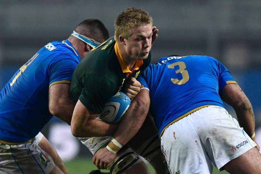South African scrum-half Ross Cronje (C) is tackled by Italian second row Marco Fuser (L) and Italian tighthead prop Simone Ferrari (R) during a Rugby Union test match between Italy and South Africa at the Euganeo Stadium in Padova on Saturday. — AFP