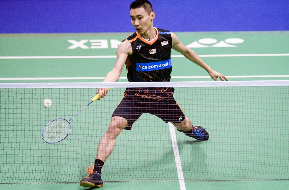 Malaysia's Lee Chong Wei goes for a shot against China's Chen Long during the men's singles final at the Hong Kong Open badminton tournament in Hong Kong on Sunday. — AFP