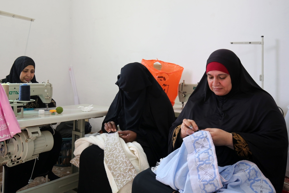 Palestinian women embroider at a workshop in Jordan's Jerash Palestinian refugee camp, which was established to host more than 11,000 Palestinians. — AFP