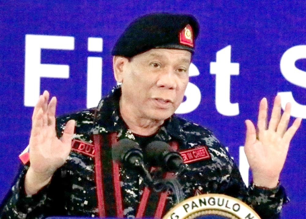 Philippine President Rodrigo Duterte, wearing a military uniform, gestures as he delivers a speech during the 67th founding anniversary of the First Scout Ranger regiment in San Miguel town, Bulacan province, north of Manila, Philippines, in this Nov. 24, 2017 file photo.— Reuters