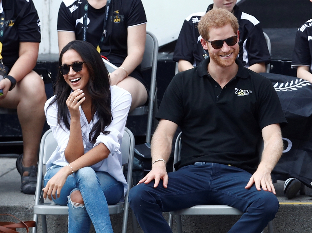 Britain's Prince Harry and his then girlfriend actress Meghan Markle watch the wheelchair tennis event during the Invictus Games in Toronto, Canada in this Sept. 25, 2017 file photo. - Reuters