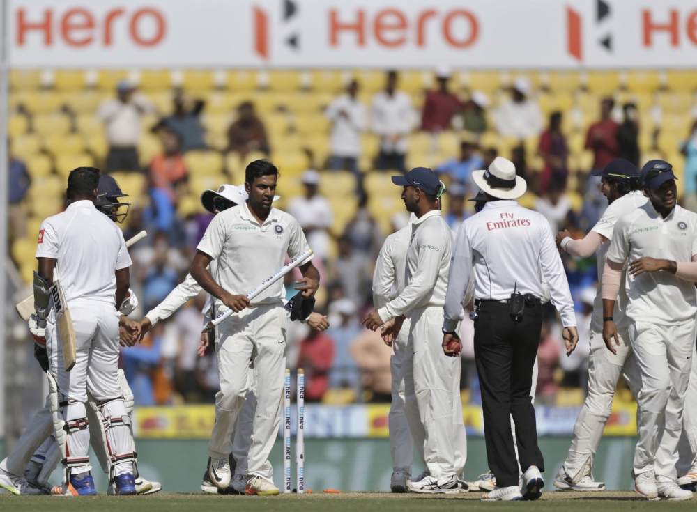 India's Ravichandran Ashwin, without cap, holds a stump as he leaves the ground after India won the second Test cricket match against Sri Lanka in Nagpur, India, Monday. Ashwin took 300 wickets in 54 Tests setting a new world record Monday. — AP