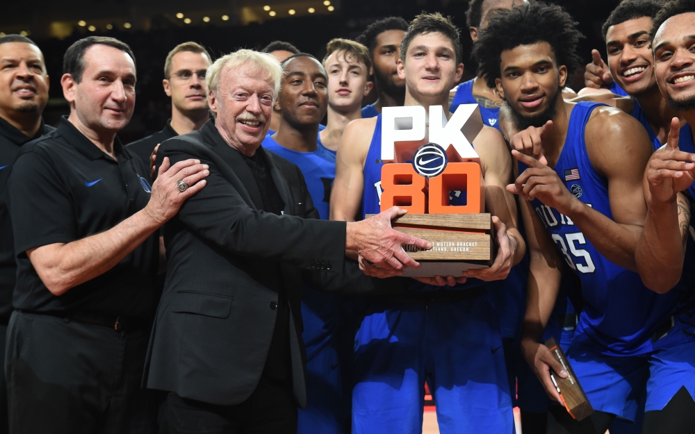 Co-founder of Nike, Phil Knight presents the Duke Blue Devils the championship trophy for the 