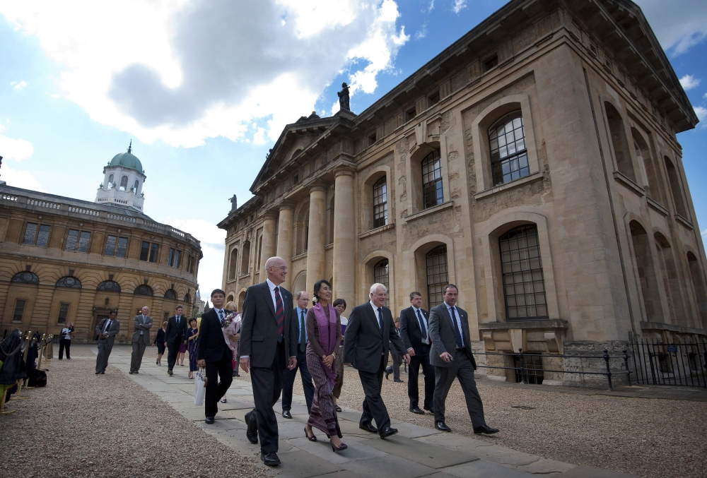 Myanmar leader Aung San Suu Kyi, center, leaves after visiting the Bodleian Libraries at Oxford University in Oxford, northwest of London, in this June 19, 2012 file photo. — AFP