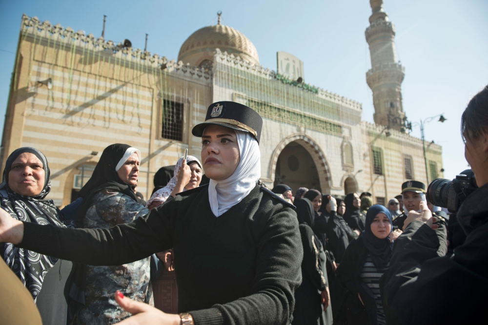 Policewomen organize mourners attending the funeral of the late popular singer and actress Shadia at the Sayeda Nafisa mosque in the capital Cairo on Wednesday. - AFP