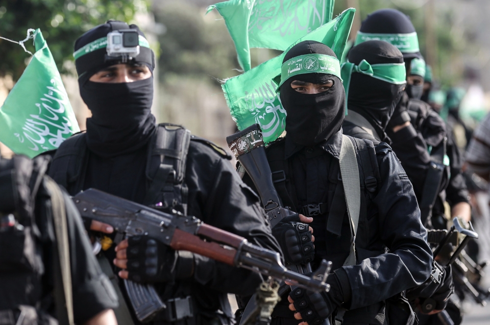 Fighters from the Ezzedine Al-Qassam Brigades, the armed wing of the Palestinian Hamas movement, march in the streets in the southern Gaza Strip city of Khan Yunis. — AFP