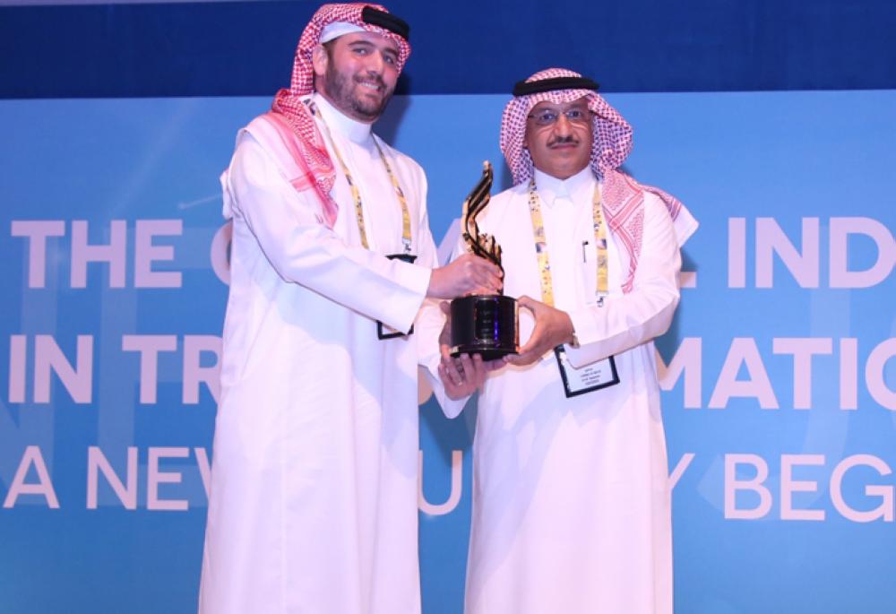 Faris Algosaibi (left), son of late Ghazi Al Gosaibi, receives the trophy on his father's behalf