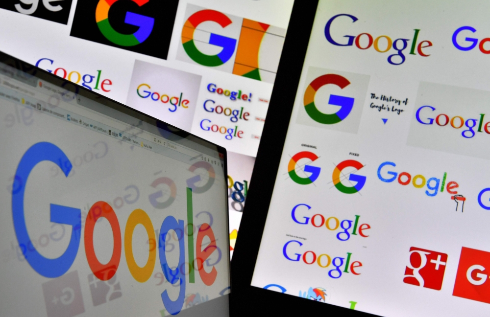 This file photo shows shows logos of US technology company Google displayed on computer screens. Google is accused of illegally collecting data belonging to more than five million UK iPhone users, in a mass legal action launched on Thursday. A campaign group dubbed 'Google You Owe us' says the tech giant owes consumers 