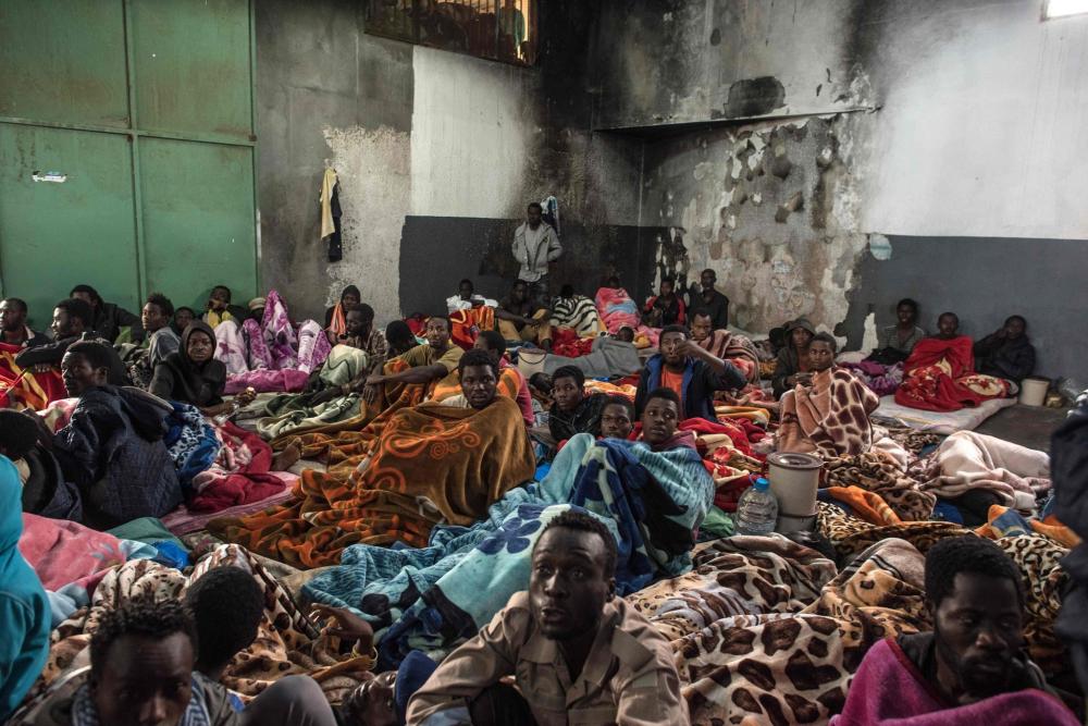 African migrants packed into the Tariq Al-Matar detention center on the outskirts of Tripoli, Libya. — AFP 