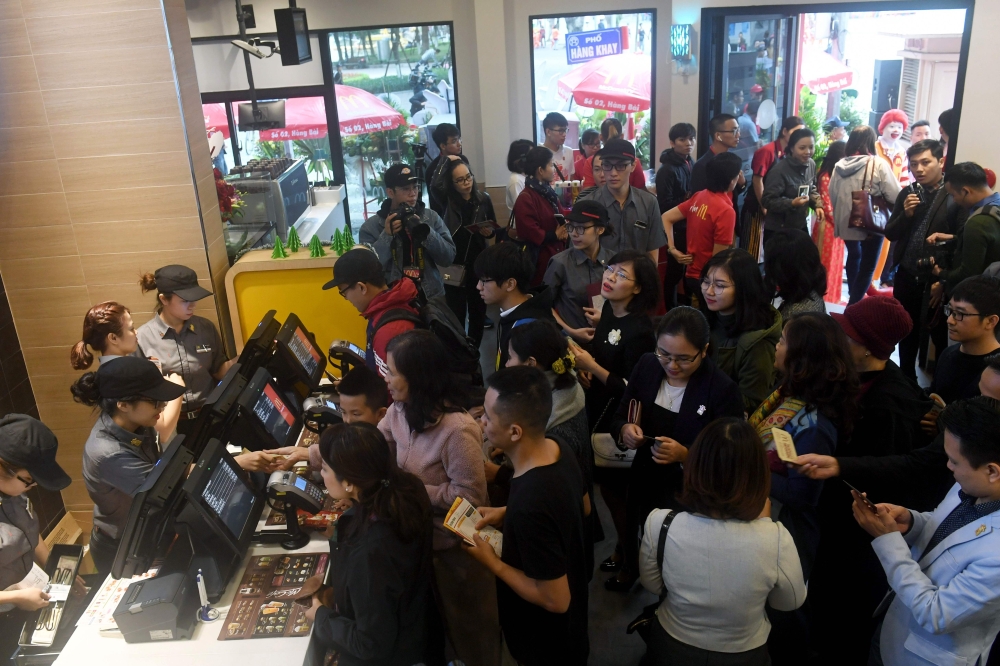 People queue up to order food on the opening day of the first McDonald’s fast food chain restaurant in Hanoi on Saturday. — AFP