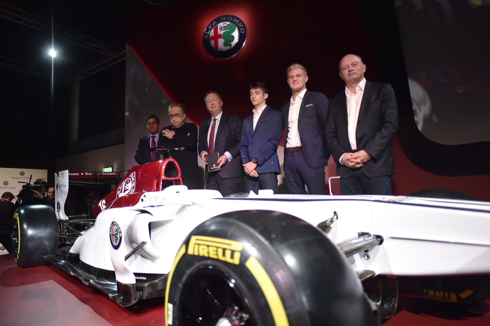 Sauber CEO Pascal Picci (L), Fiat Chrysler Automobiles CEO Sergio Marchionne (2L), Monegasque racing driver Charles Leclerc (3R), Swedish Sauber F1's driver Marcus Ericsson (2R) and others unveil the new Alfa Romeo Sauber Formula One Team car on Saturday at the Alfa Romeo Historical Museum in Arese, near Milan. Alfa Romeo are returning to Formula One after a 30 year absence as backers of Sauber next year. The Ferrari-powered team will be known as Alfa Romeo Sauber. — AFP