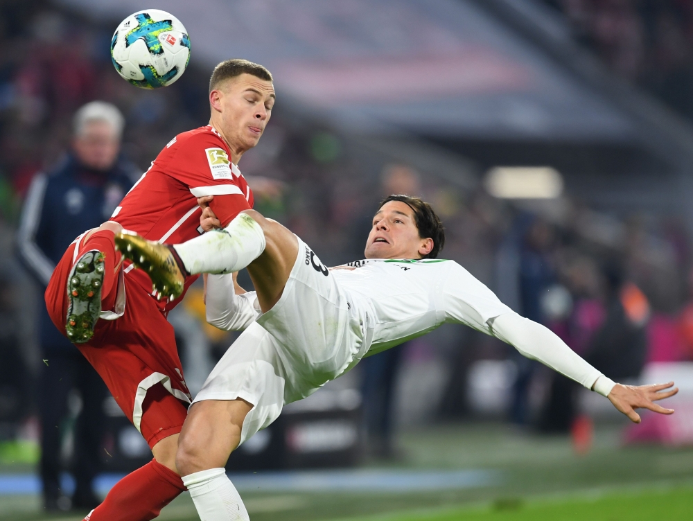 Bayern Munich's midfielder Joshua Kimmich (L) and Hanover's Chilean defender Miiko Albornoz (R) vie for the ball during the German First division Bundesliga football match Bayern Munich vs Hannover 96 on Saturday in Munich.