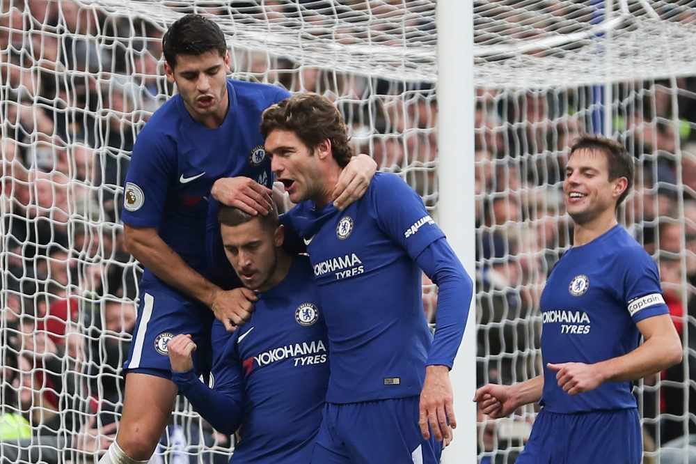Chelsea's Belgian midfielder Eden Hazard (2L) celebrates with teammates after scoring his team's third goal, and his second goal, from the penalty spot during the English Premier League football match between Chelsea and Newcastle United at Stamford Bridge in London on December 2, 2017. RESTRICTED TO EDITORIAL USE. No use with unauthorized audio, video, data, fixture lists, club/league logos or 'live' services. Online in-match use limited to 75 images, no video emulation. No use in betting, games or single club/league/player publications. 
 / AFP / Daniel LEAL-OLIVAS / RESTRICTED TO EDITORIAL USE. No use with unauthorized audio, video, data, fixture lists, club/league logos or 'live' services. Online in-match use limited to 75 images, no video emulation. No use in betting, games or single club/league/player publications. 
