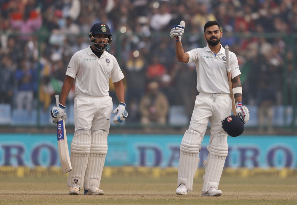 India's Rohit Sharma, left, looks on as captain Virat Kohli, right, gestures after scoring a double century during the second day of their third Test cricket match against Sri Lanka in New Delhi on Sunday. — AP