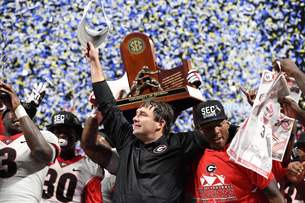 Georgia Bulldogs head coach Kirby Smart reacts as his players lift the Southeastern Conference trophy after a victory over the Auburn Tigers in the SEC Championship game at Mercedes-Benz Stadium. Georgia defeated Auburn 28-7. — Reuters