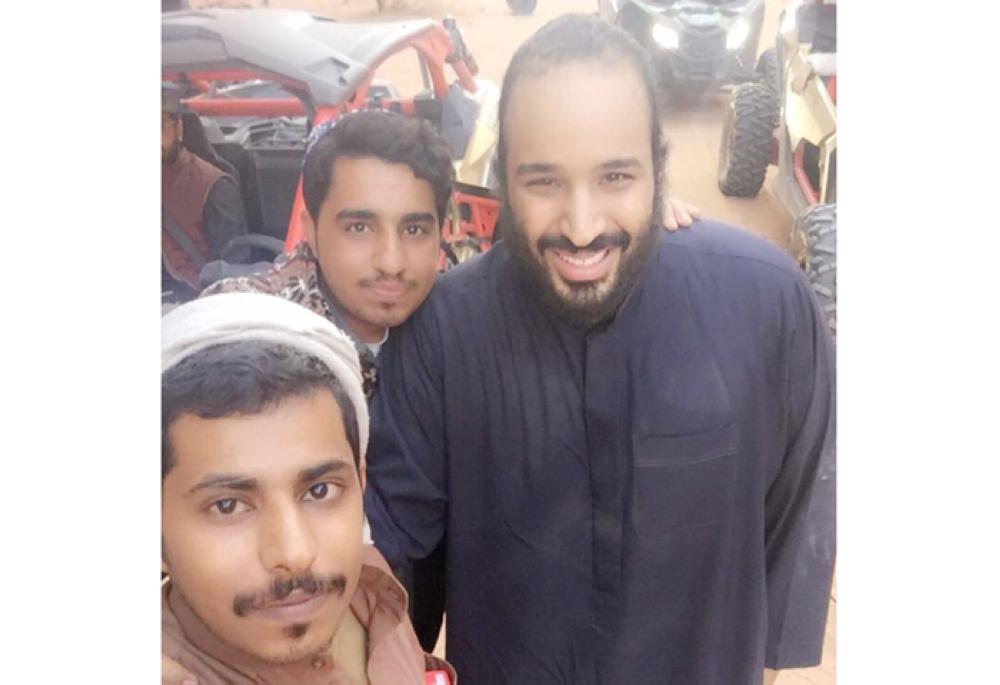 Visitors to the Al-Ula mountains in Madinah take selfies with Crown Prince Muhammad Bin Salman, deputy premier and minister of defense. — Social media photo