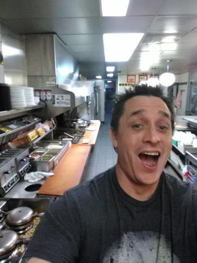 Alex Bowen poses in the kitchen at a Waffle House in West Columbia, South Carolina over the weekend. - AP