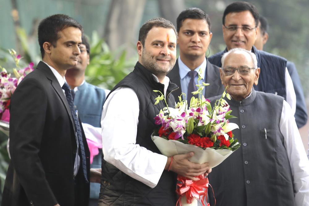 Senior Congress party leaders welcome their party vice president Rahul Gandhi , second left, with flowers as he arrives to file his nomination papers at party headquarters, in New Delhi, India, on Monday. — AP