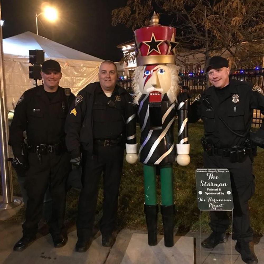 Steubenville police pose with a human-sized nutcracker modeled after David Bowie shortly after they recovered the giant nutcracker in Steubenville, Ohio on Monday.