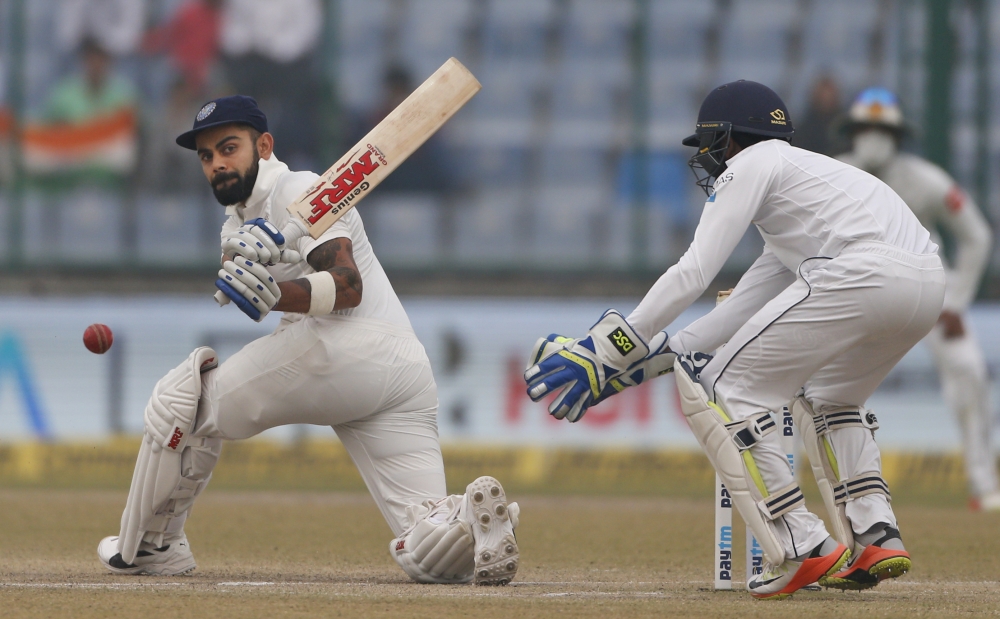 India's captain Virat Kohli plays a sweep shot during the fourth day of their third Test cricket match against Sri Lanka in New Delhi, India, Tuesday. — AP