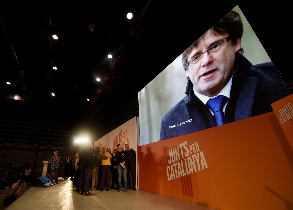 A picture of ‘Junts per Catalonia’ (All for Catalonia) grouping candidate for the upcoming Catalan regional election, Carles Puigdemont, is displayed on a screen during the campaign opening meeting in Barcelona, on Monday. — AFP